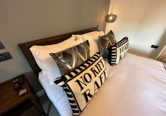 A bed with a pillow that says no rail on it