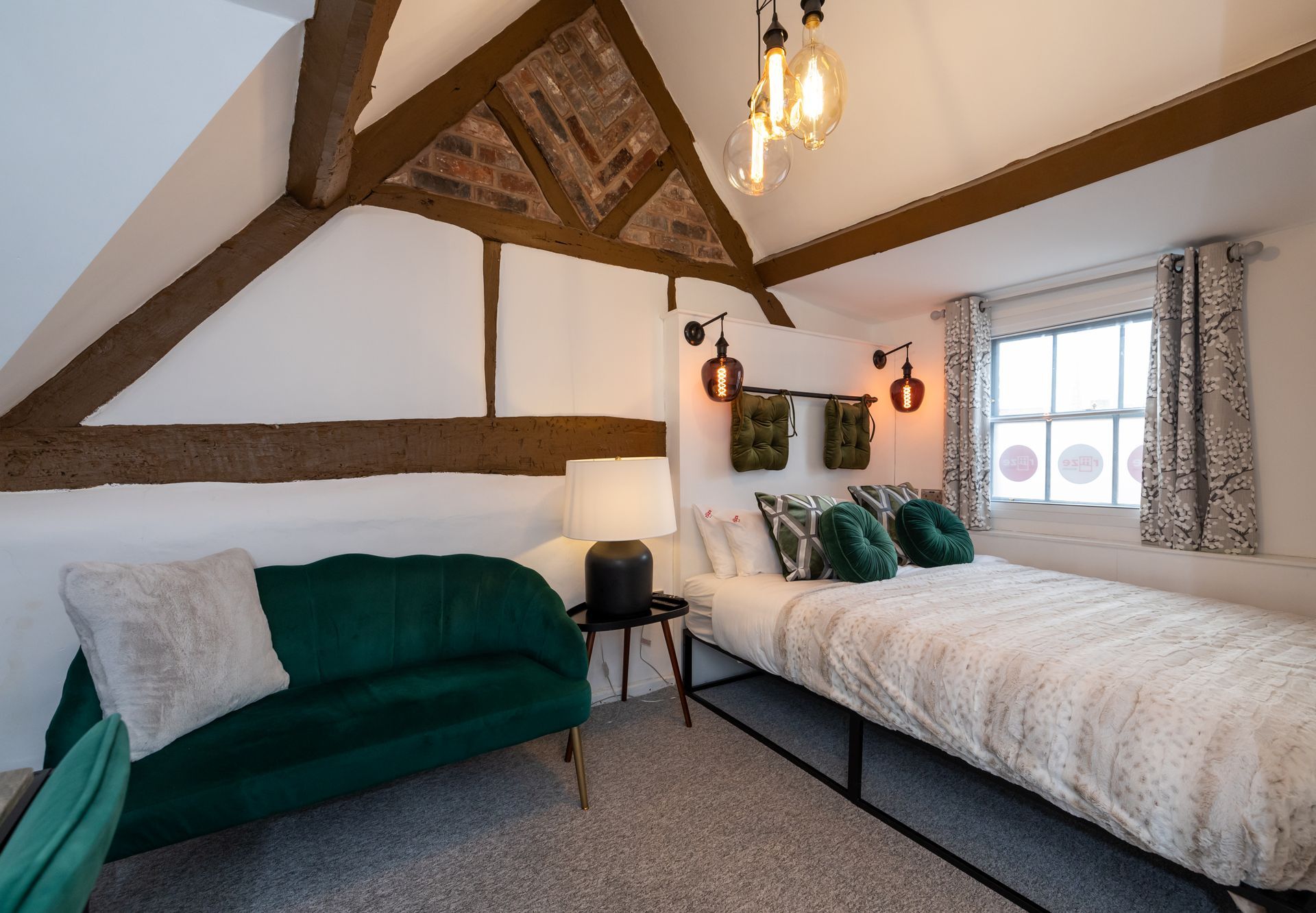 There is a bed and a couch in the room.