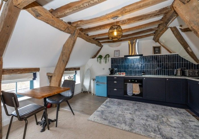 A kitchen with a table and chairs in it