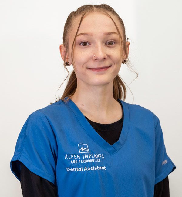 A woman wearing a blue dental assistant uniform