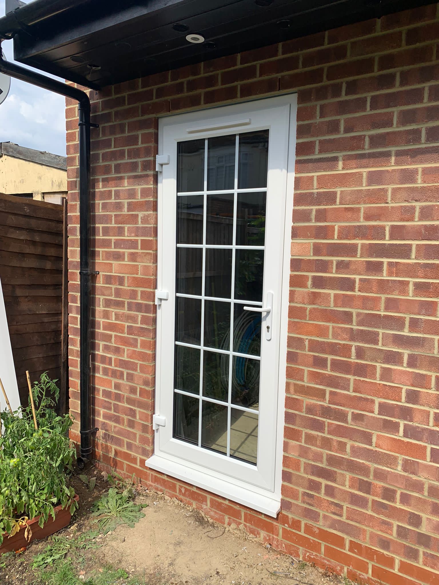 A brick building with a white door on it.