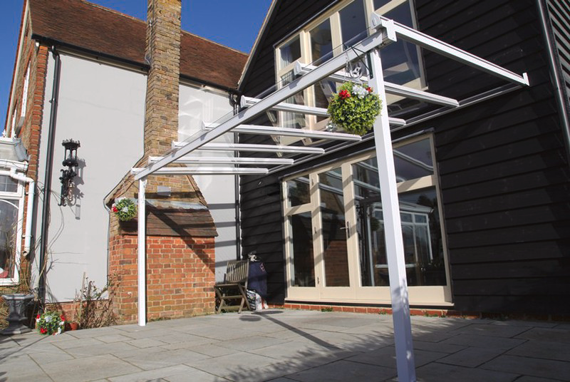 A house with a white canopy on the side of it