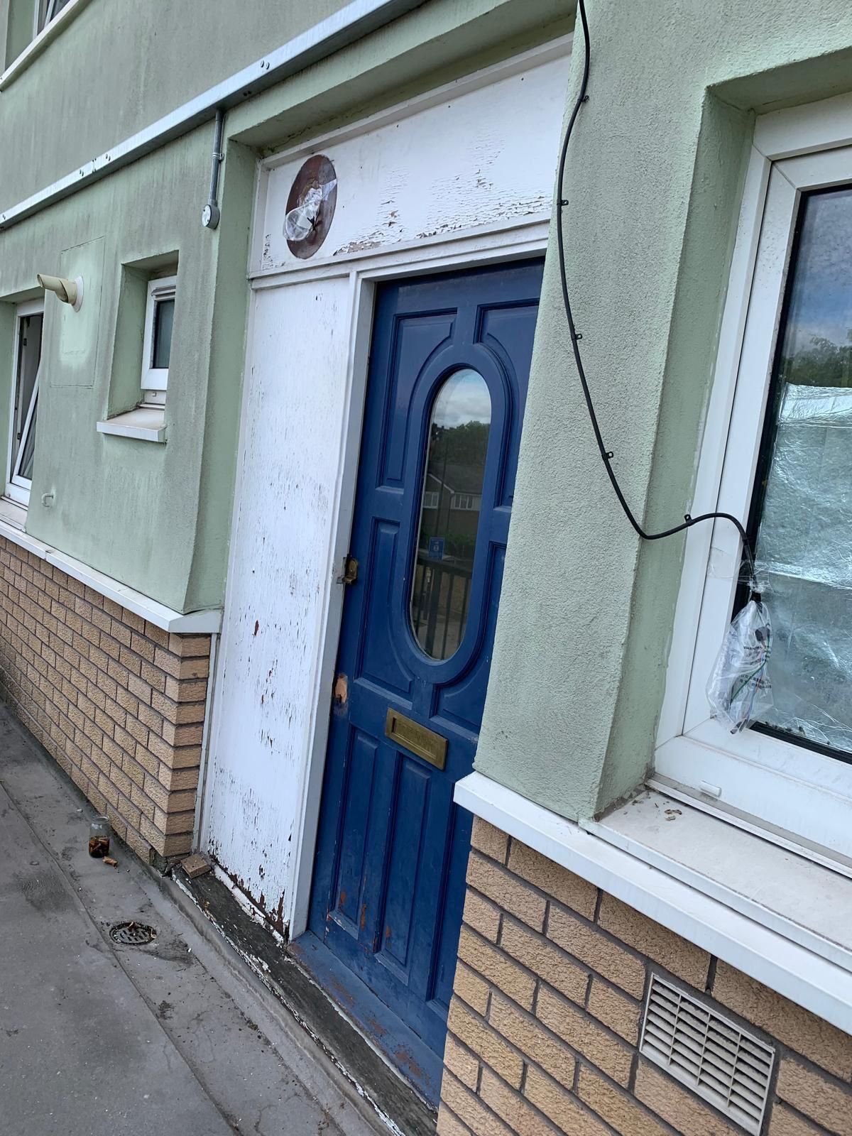 A blue door is on the side of a building