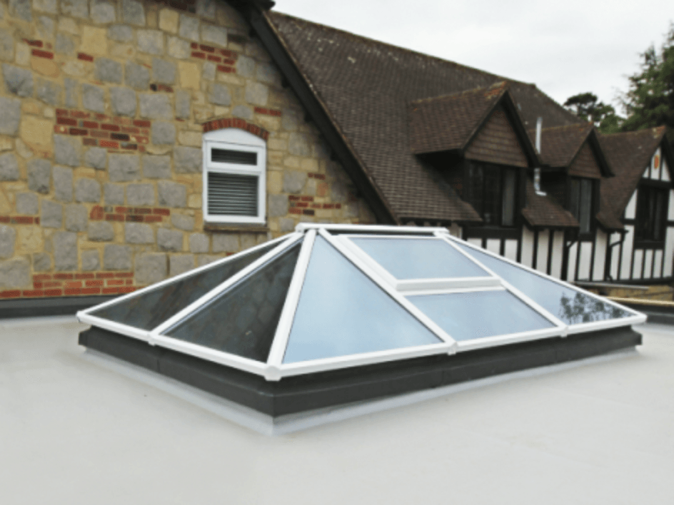 A pyramid shaped skylight on the roof of a house