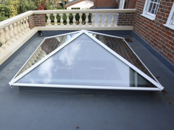 A skylight on the roof of a brick building
