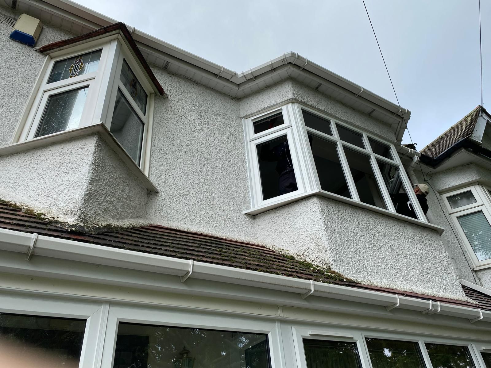 A house with a lot of windows and a roof.