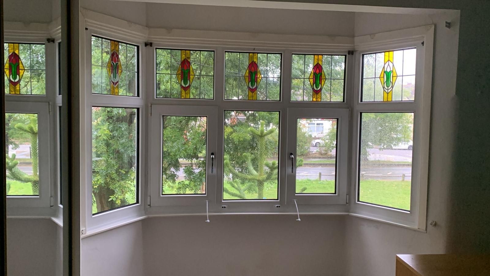 A room with a lot of windows and a stained glass window