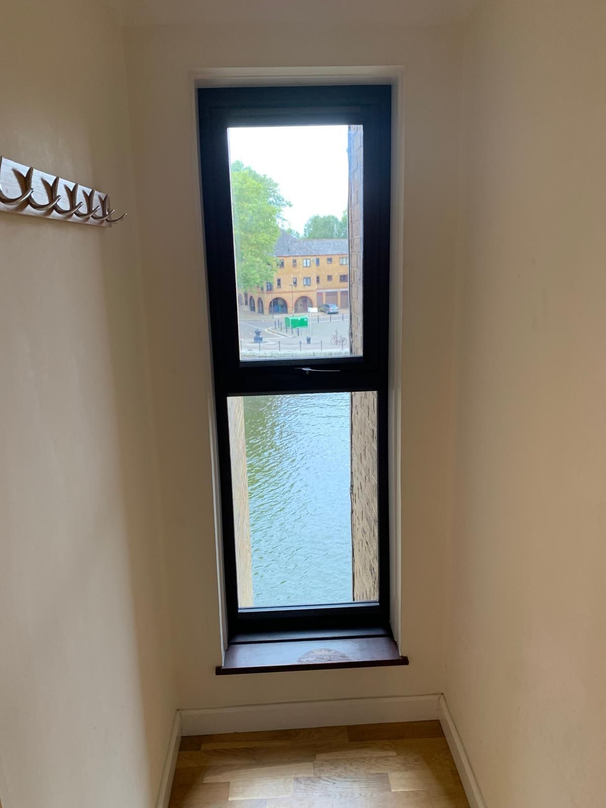 A window in a room with a view of a river.