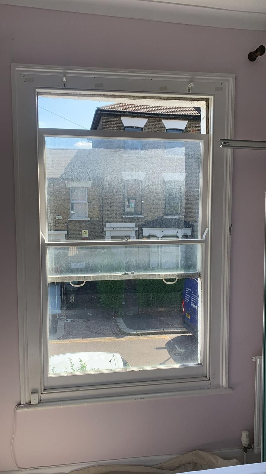 A window in a room with a view of a house.