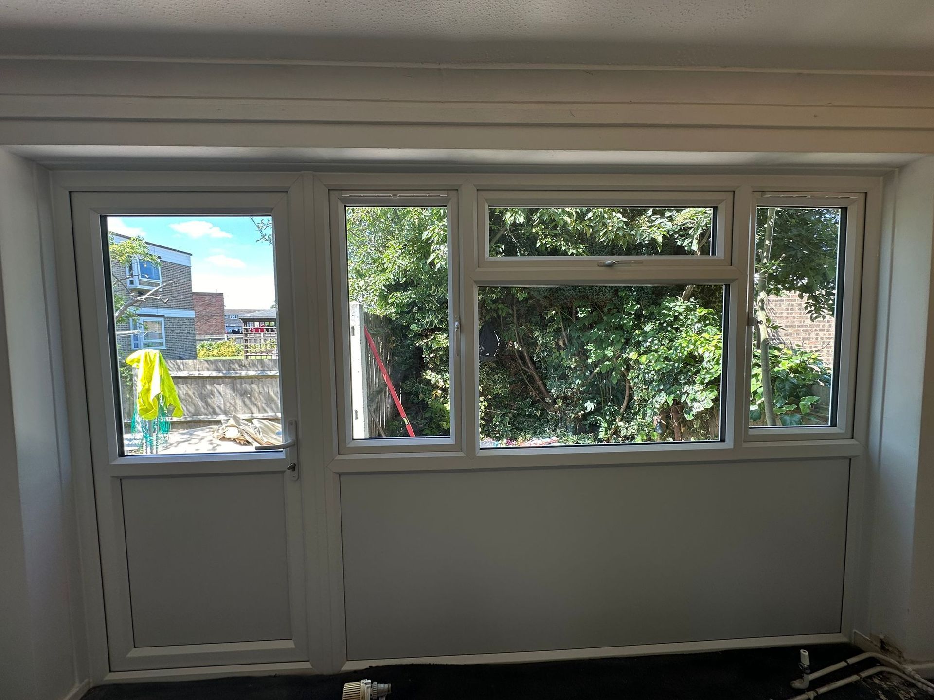 A room with a lot of windows and a door.