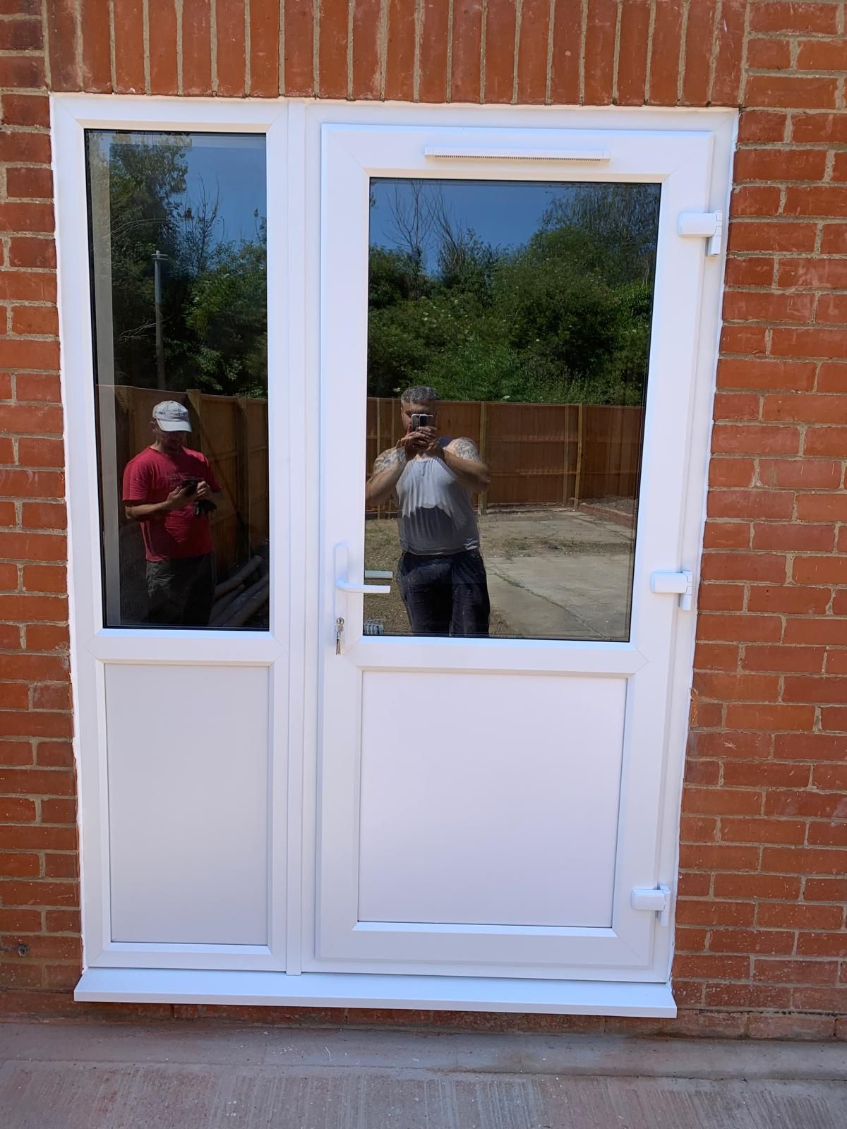 A man is taking a picture of himself in a doorway
