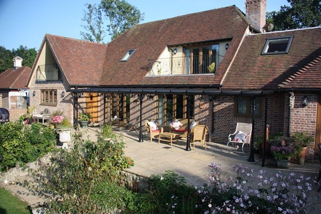A large brick house with a patio in front of it