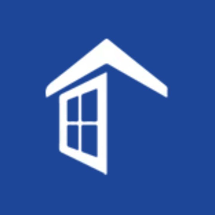 a white icon of a house with a window on a blue background .