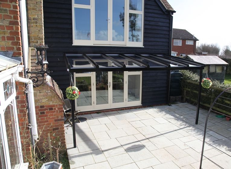 A black house with a patio in front of it