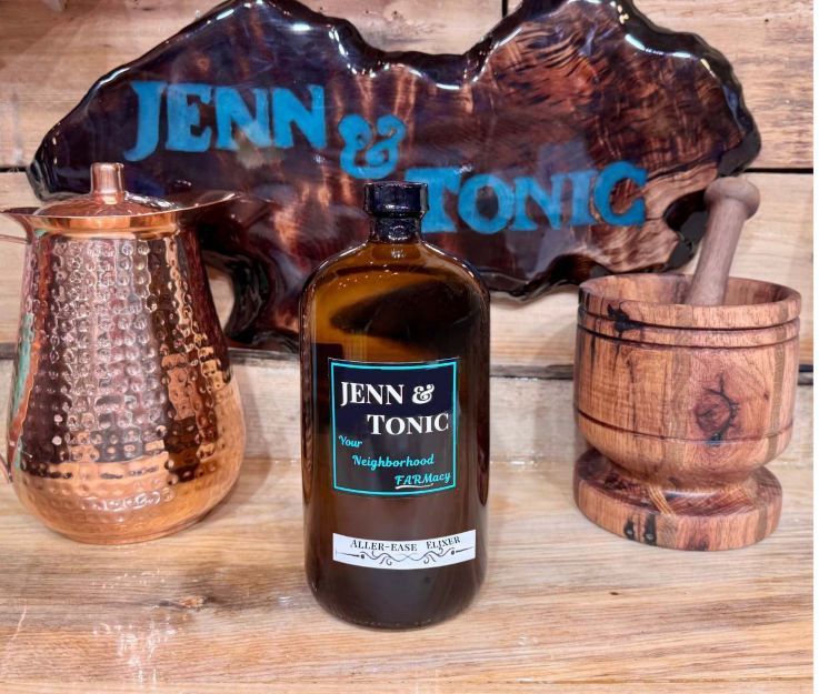 A bottle of jenn & tonic is sitting on a wooden table