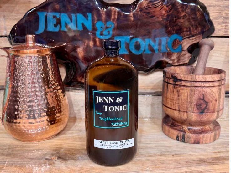 A bottle of jenn & tonic is sitting on a wooden table