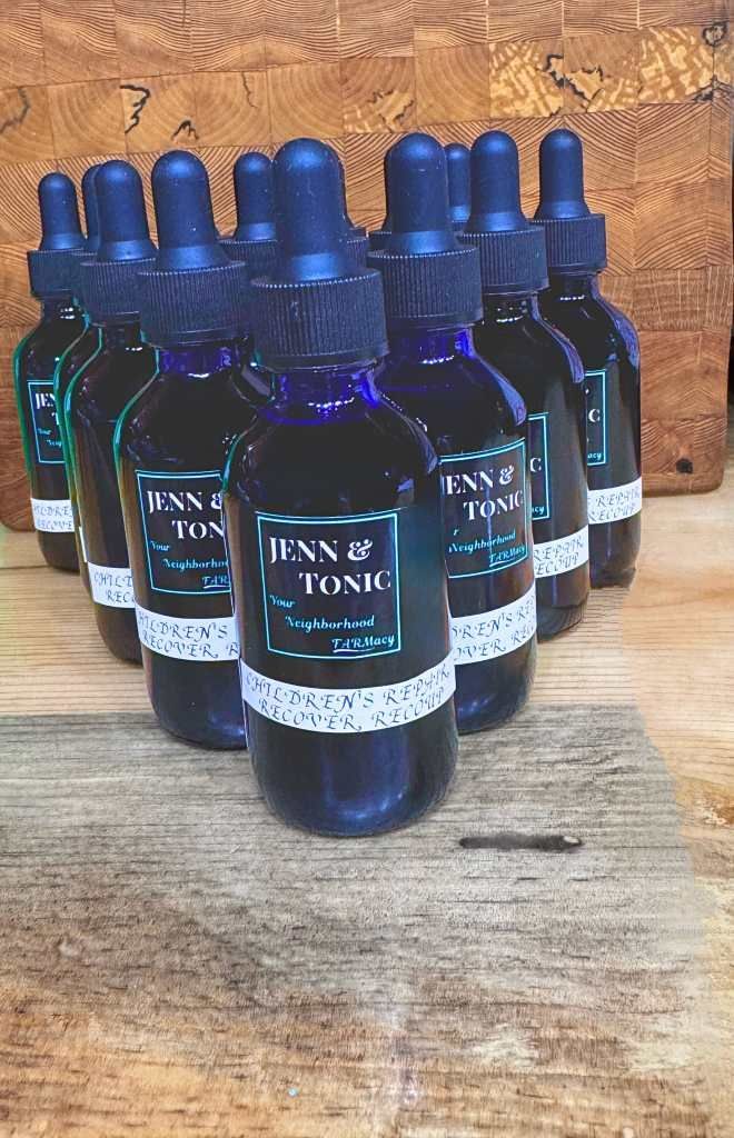 A group of bottles sitting on top of a wooden table.