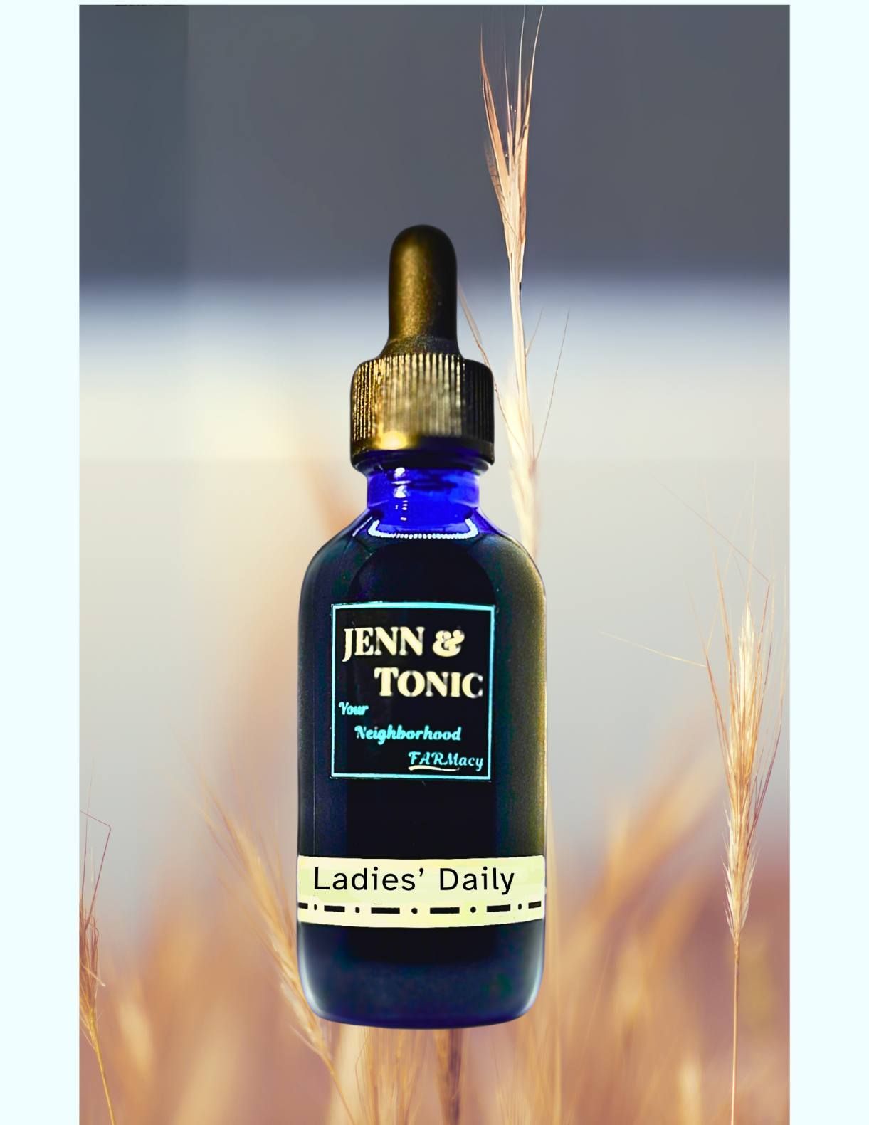 A bottle of jenn & tonic is sitting in front of a wheat field.