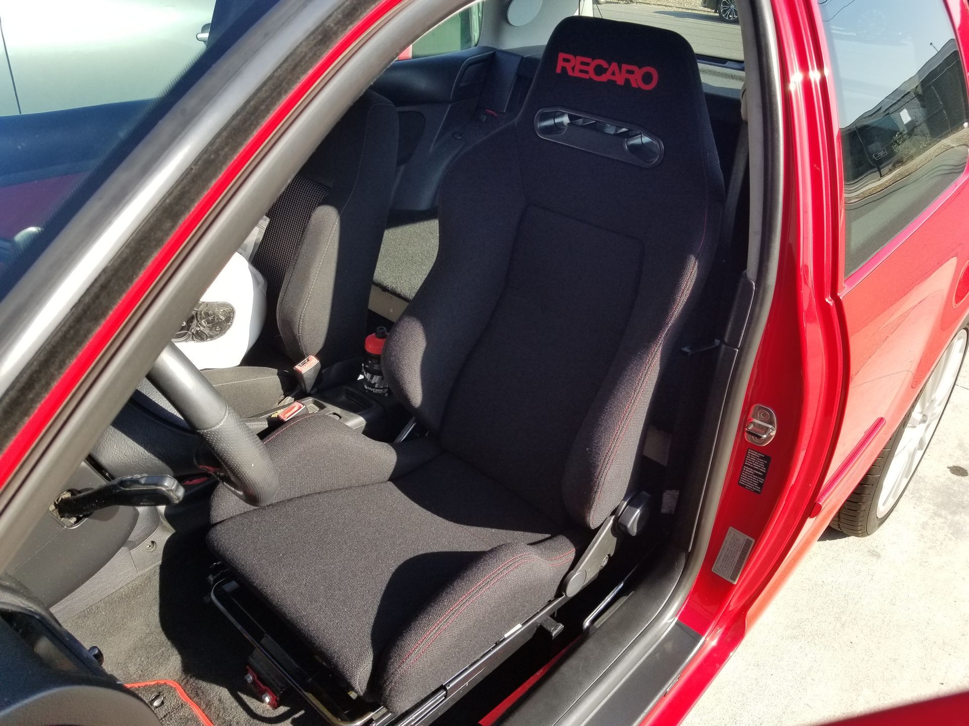 A red car with a black recaro seat | Griffin Motorwerke