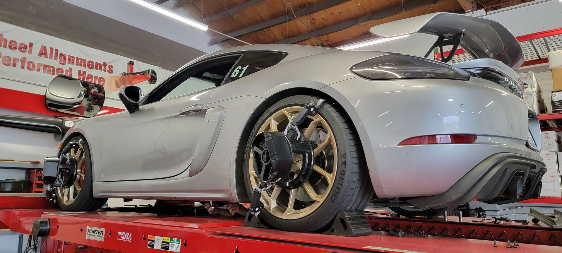 A silver sports car is sitting on top of a red ramp in a garage | Griffin Motorwerke