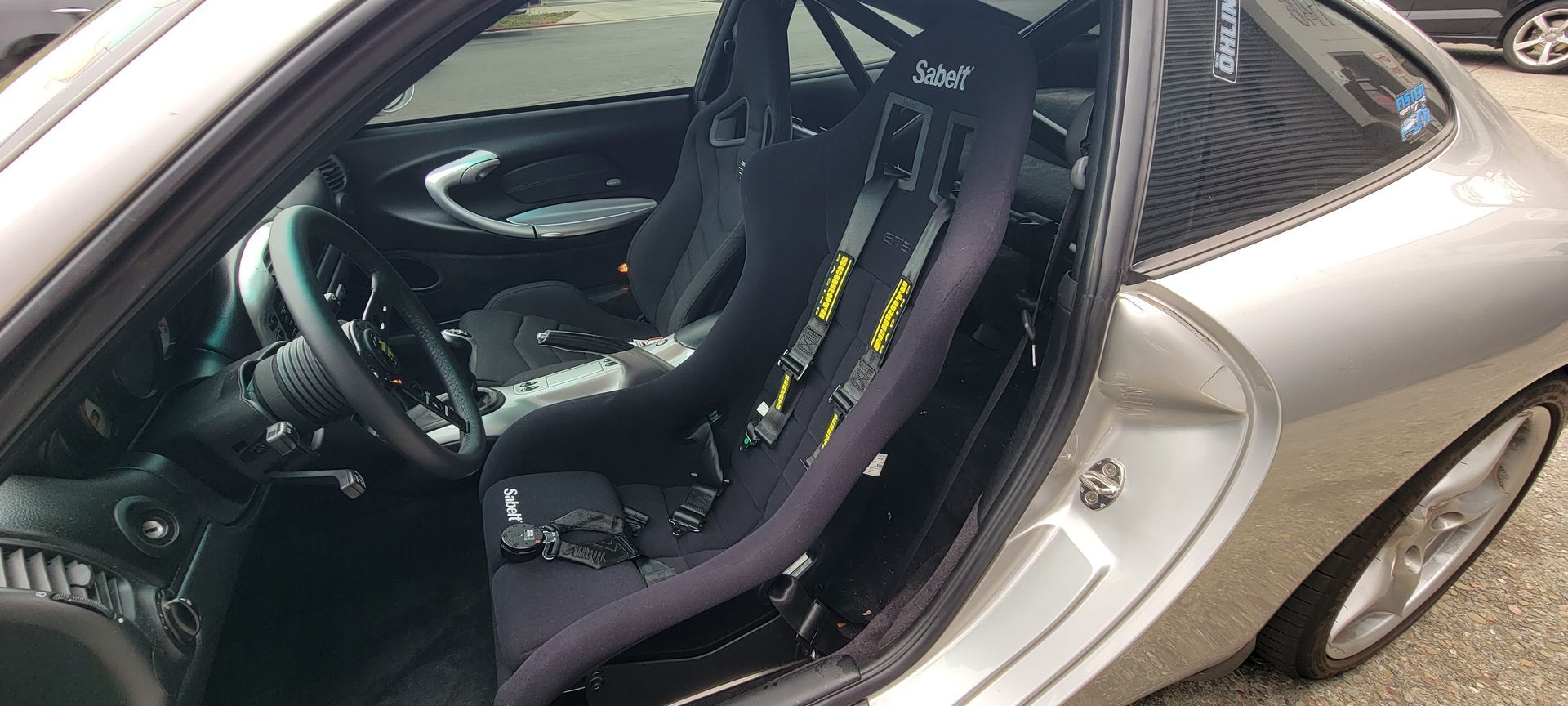 The inside of a silver sports car with the door open | Griffin Motorwerke