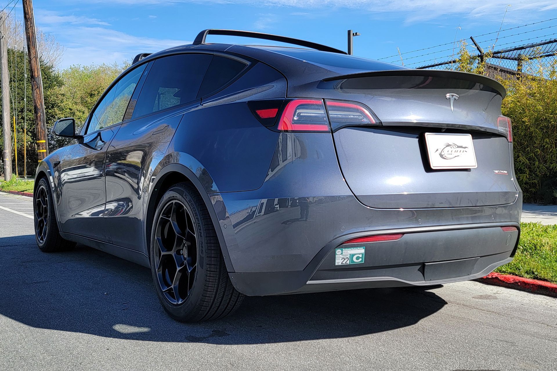 A tesla model y is parked on the side of the road | Griffin Motorwerke