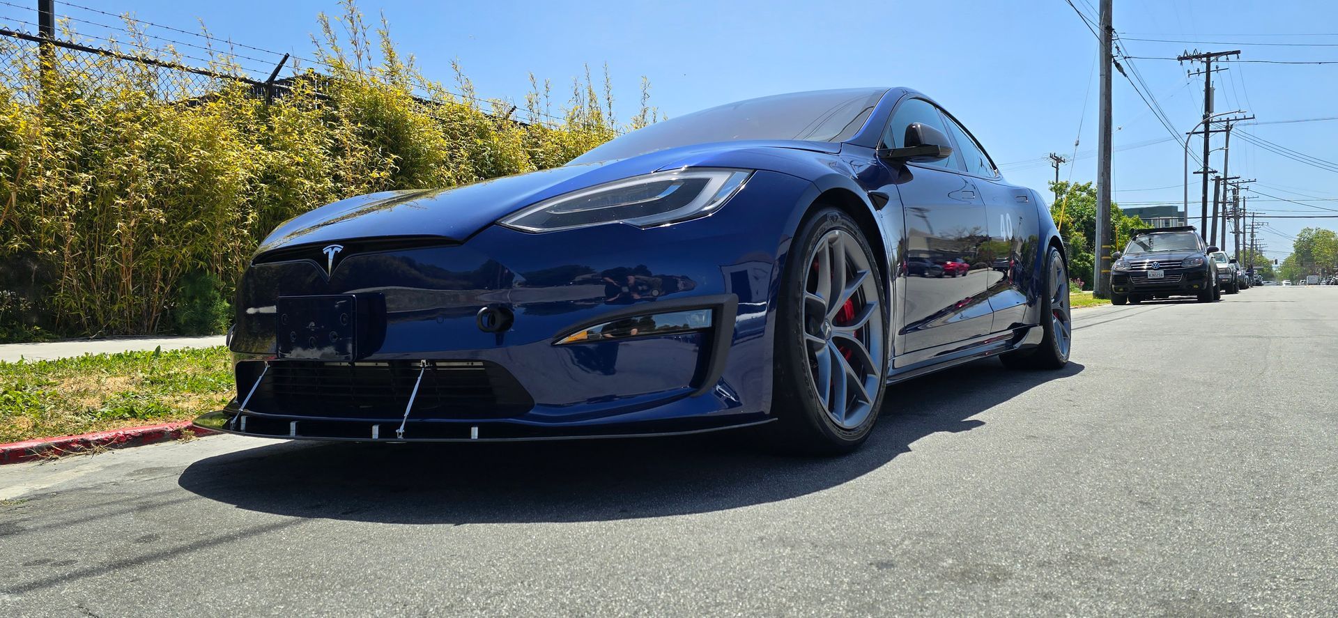 A blue tesla model s is parked on the side of the road | Griffin Motorwerke