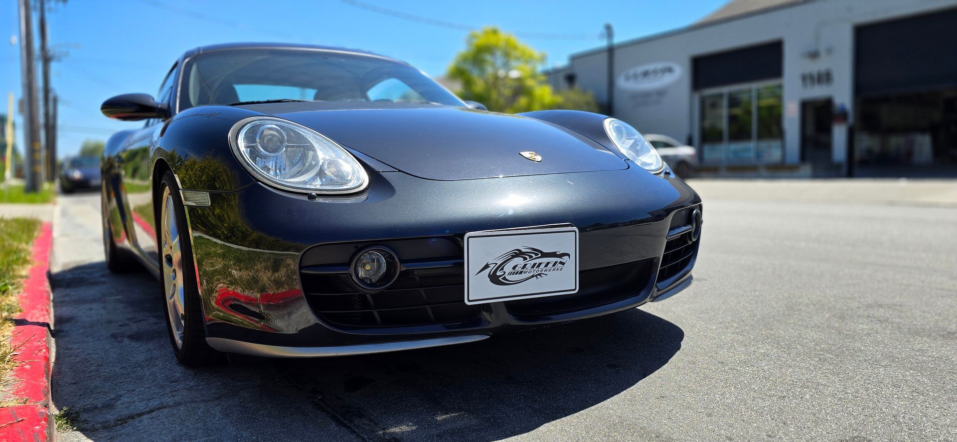 A black sports car is parked on the side of the road | Griffin Motorwerke