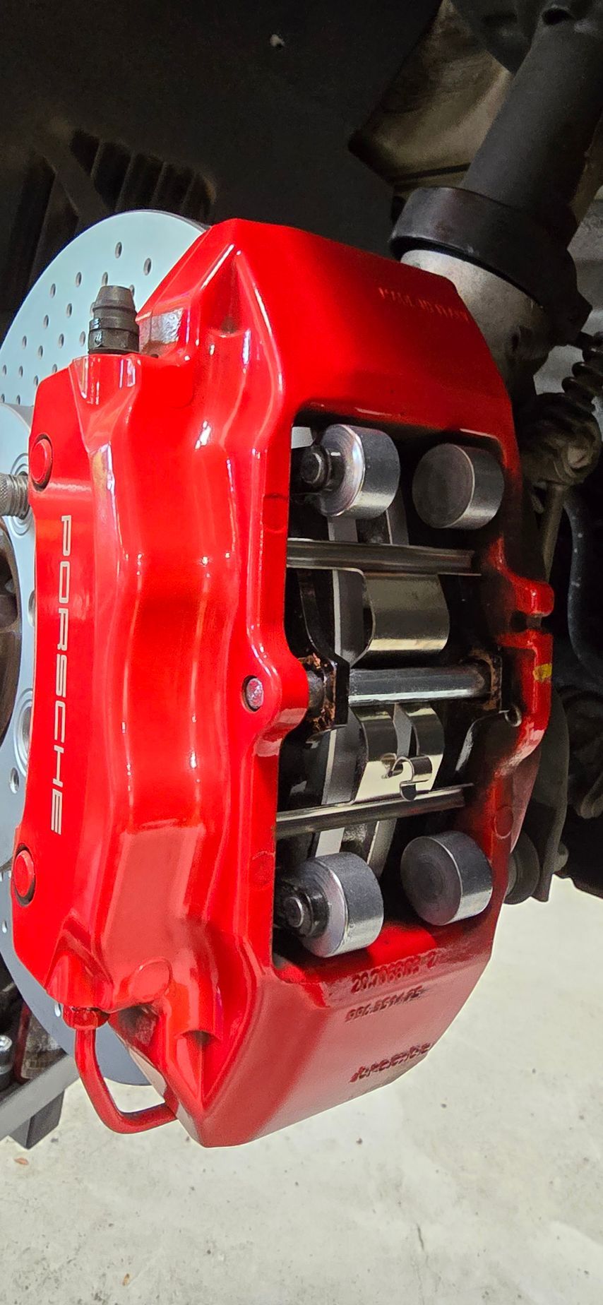 A close up of a red brake caliper on a car | Griffin Motorwerke