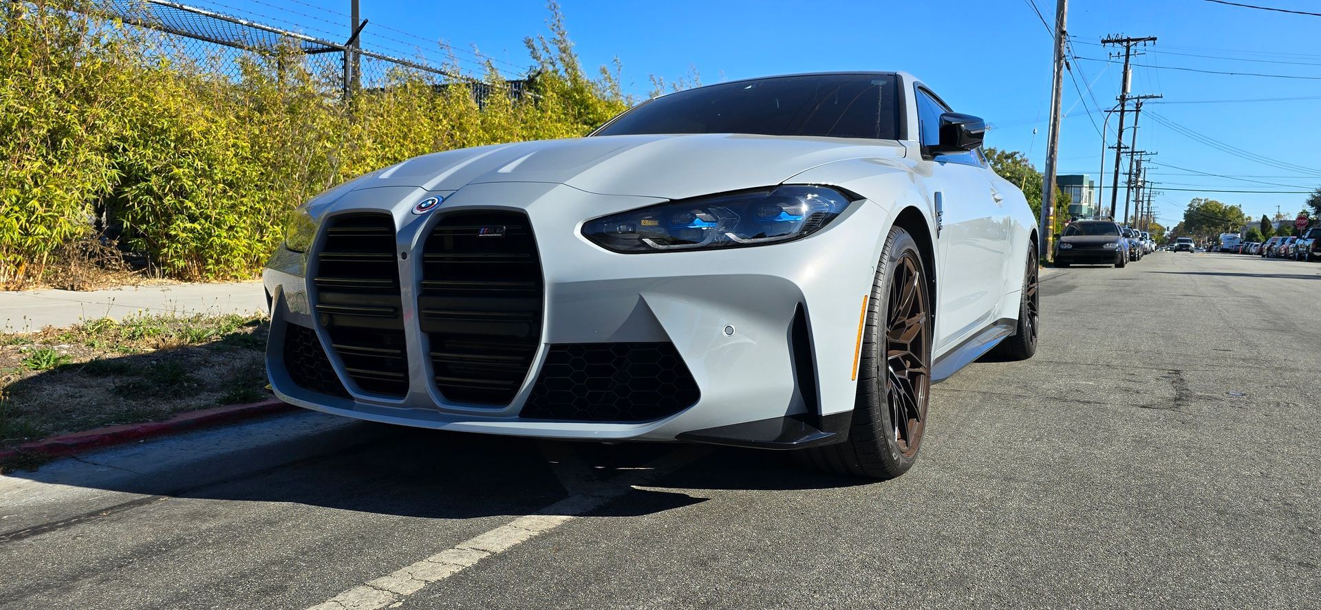 A white bmw m4 is parked on the side of the road | Griffin Motorwerke