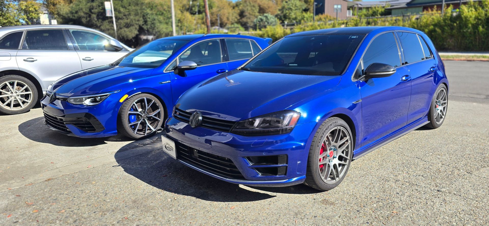 Two blue cars are parked next to each other in a parking lot | Griffin Motorwerke
