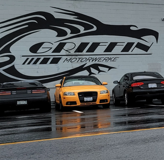 Three cars are parked in front of a building that says griffin motorwerke | Griffin Motorwerke