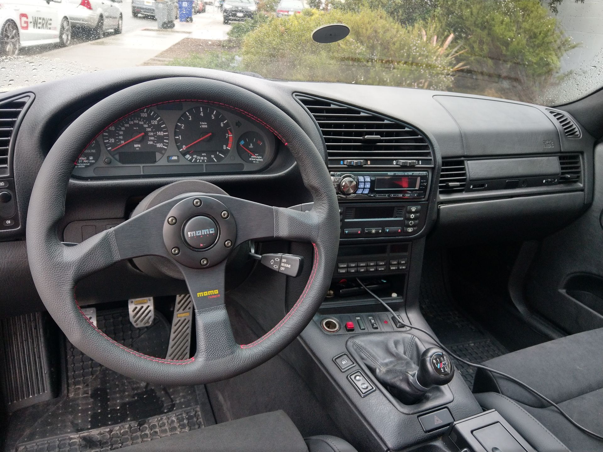 The inside of a car with a momo steering wheel | Griffin Motorwerke