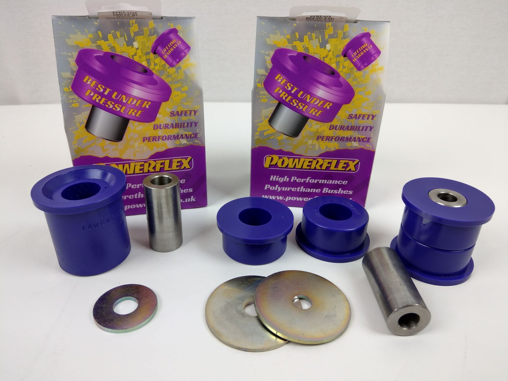 Two boxes of powerflex bushings are sitting on a table | Griffin Motorwerke