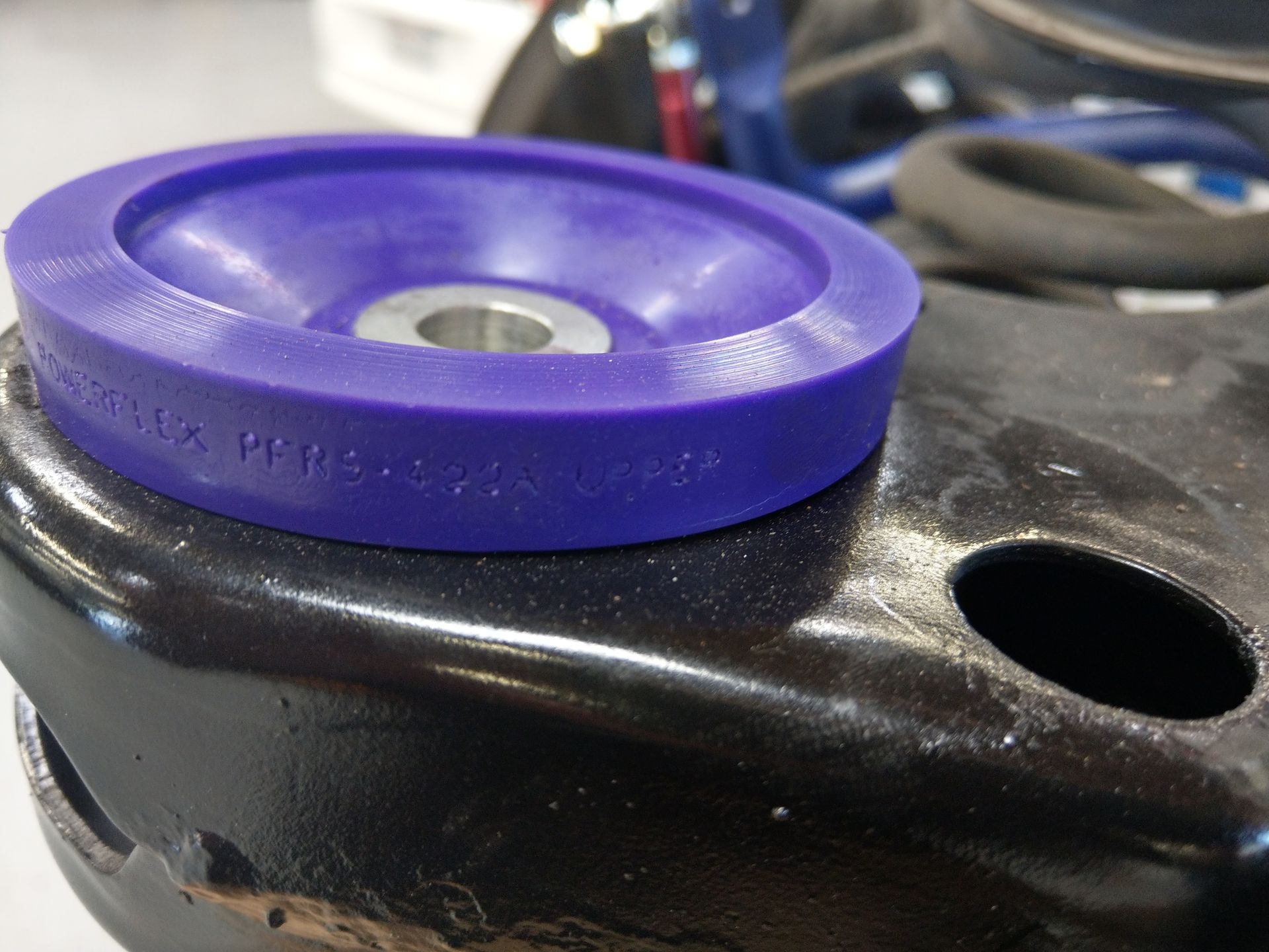 A purple rubber ring is sitting on top of a black piece of metal | Griffin Motorwerke