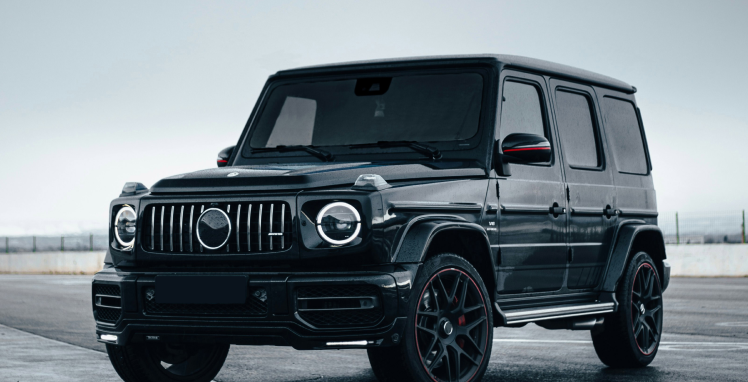 A black mercedes benz g63 is parked in a parking lot | Griffin Motorwerke