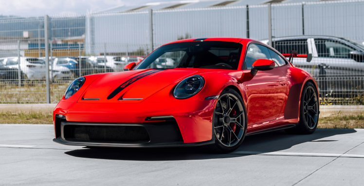 A red porsche 911 gt3 is parked on the side of the road | Griffin Motorwerke