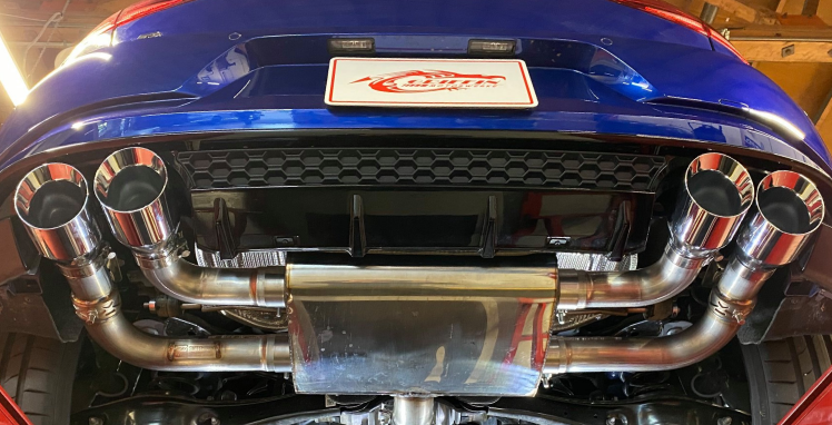 The exhaust pipes on the back of a blue car are stainless steel | Griffin Motorwerke