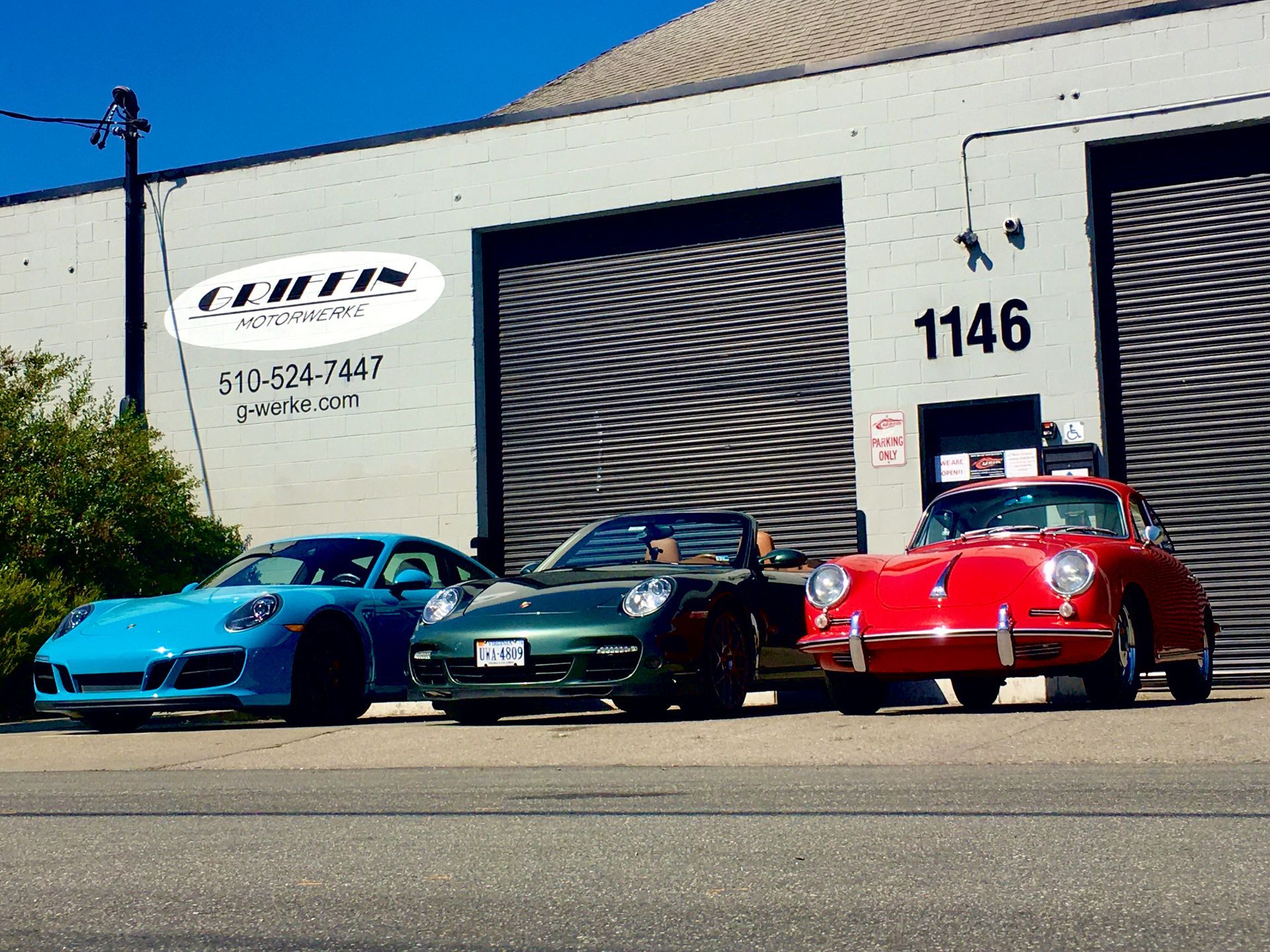 Three cars are parked in front of a building with the number 1136 on it | Griffin Motorwerke
