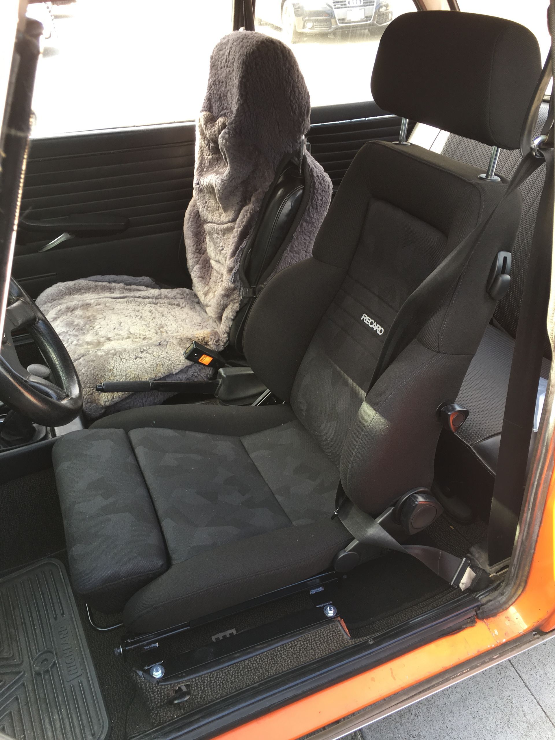 A close up of a car seat in an orange car | Griffin Motorwerke