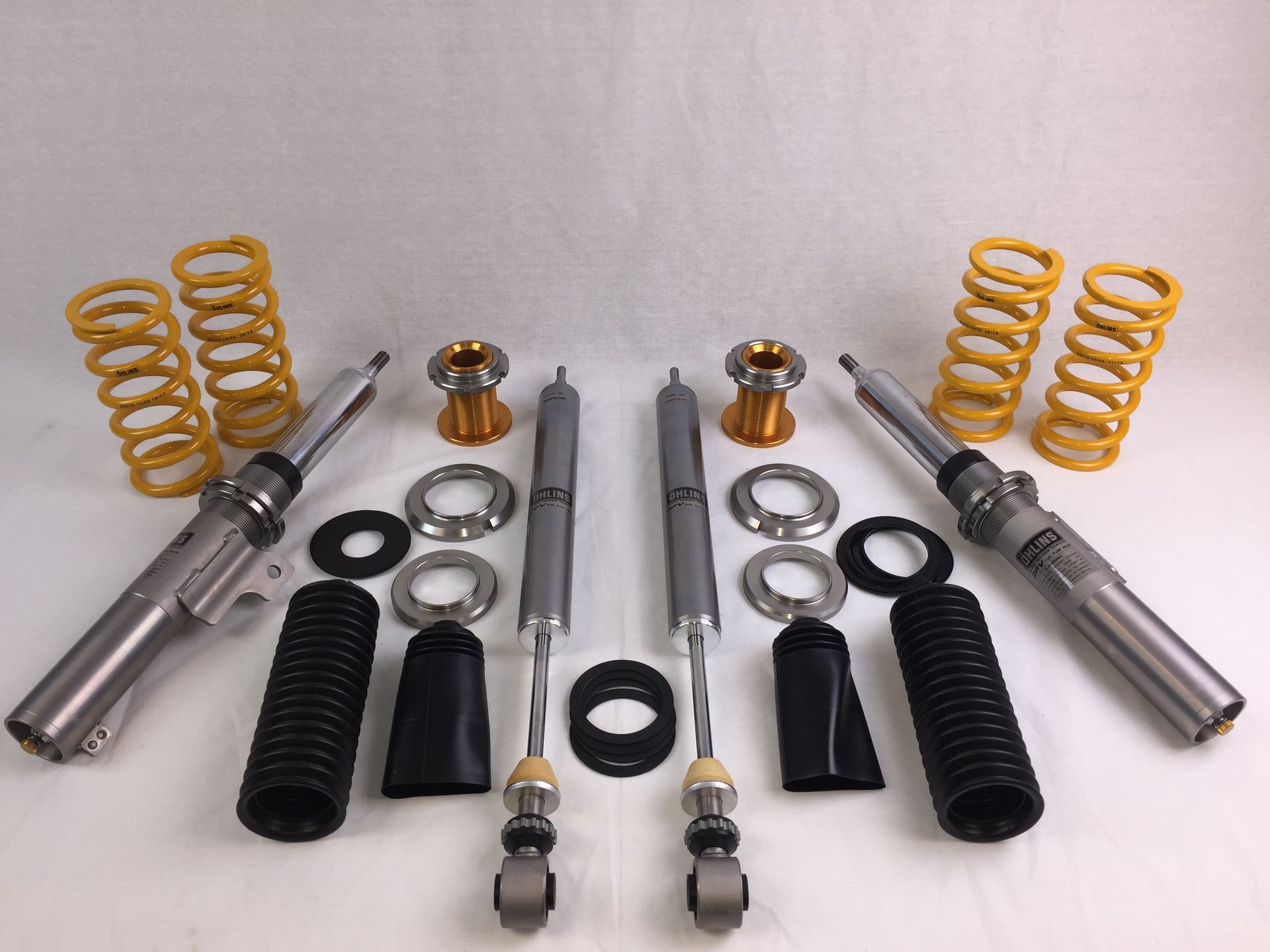 A bunch of shocks and springs on a white surface | Griffin Motorwerke