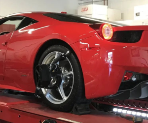 A red sports car is sitting on a ramp in a garage | Griffin Motorwerke