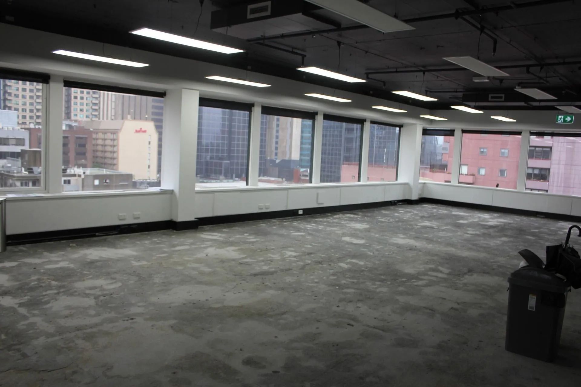 A large empty room with a lot of windows