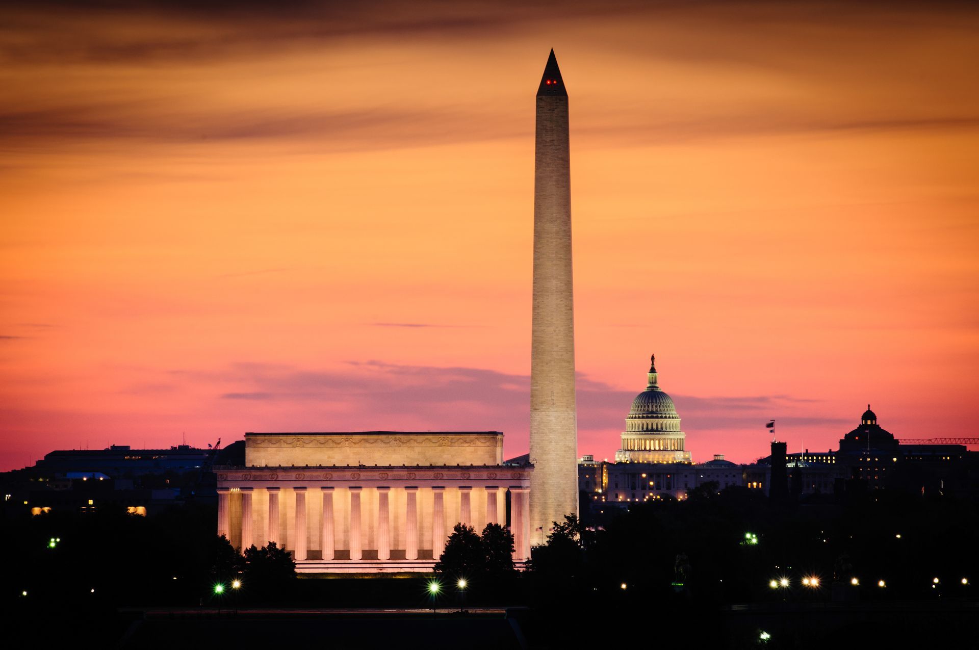 The washington monument is lit up at night in washington d.c.