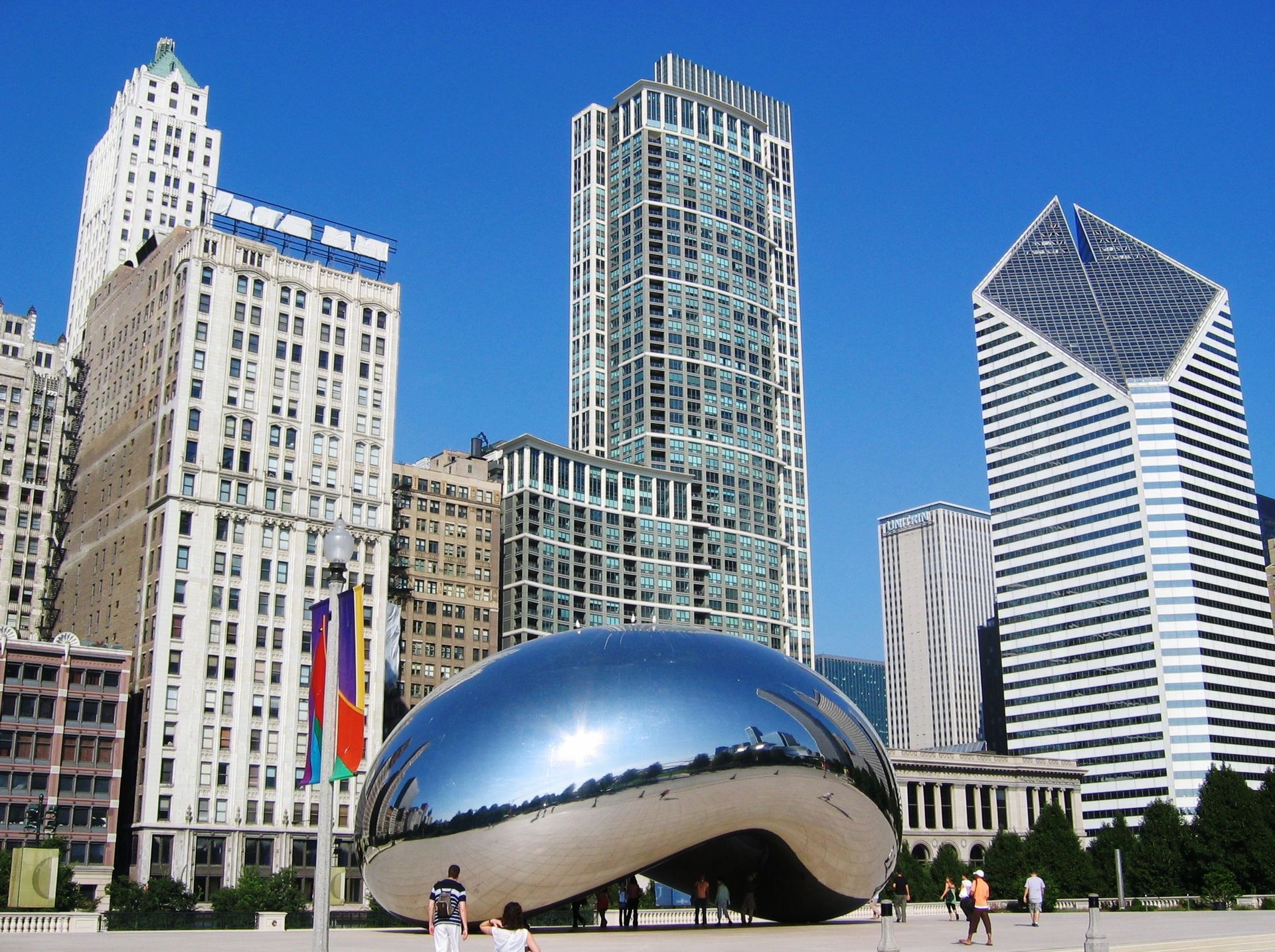 A cityscape with a bean sculpture in the foreground