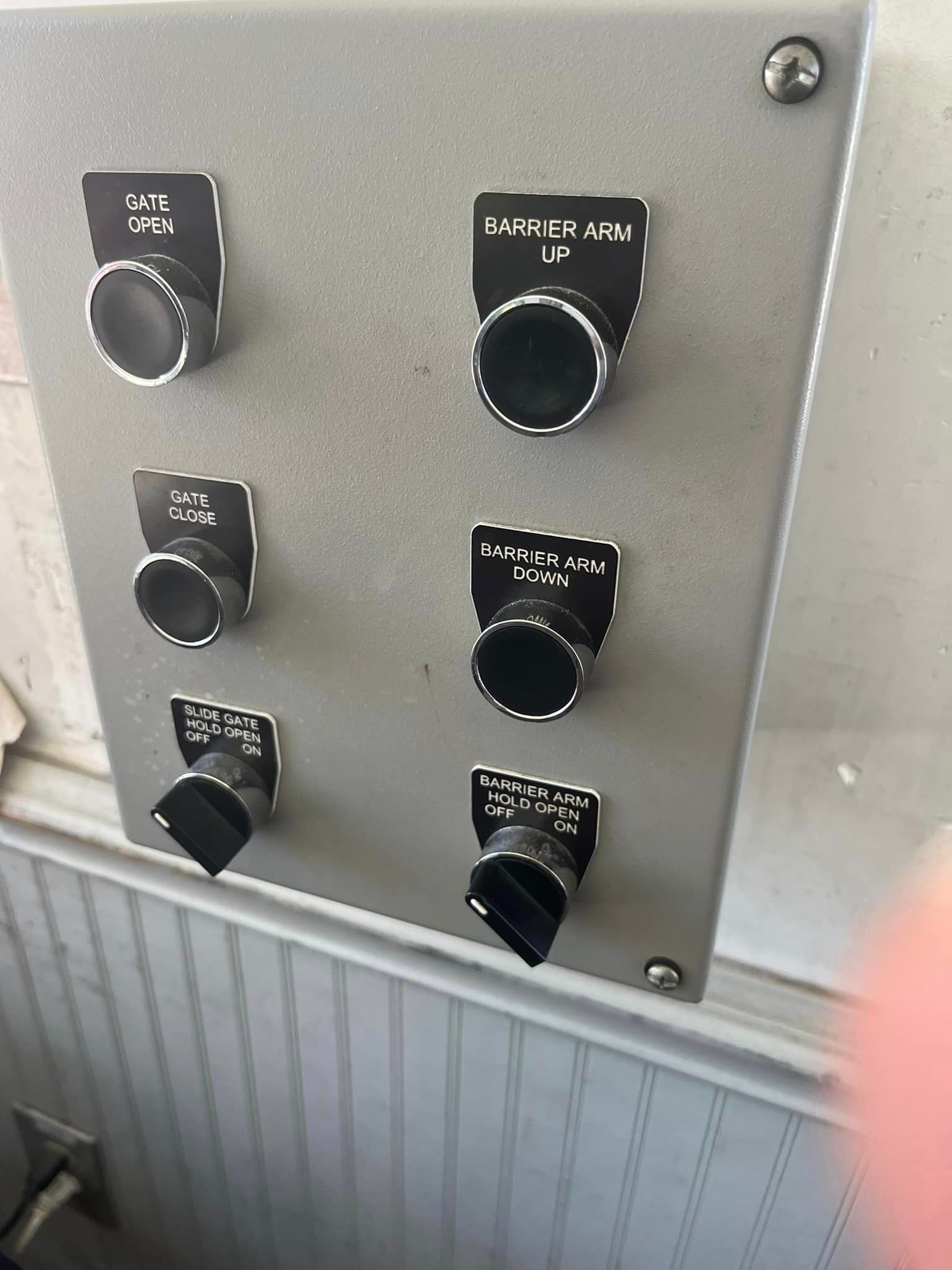 Gray metal control panel with six black switches 