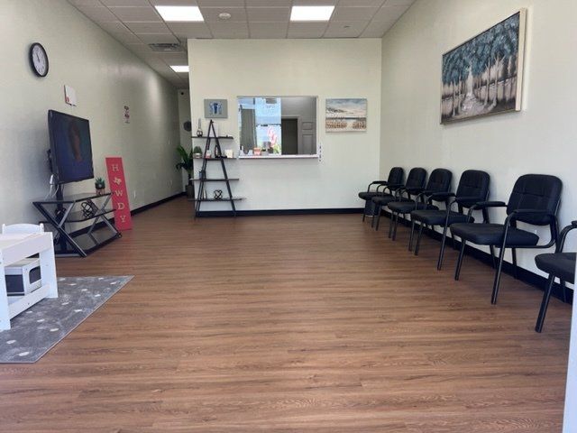 A waiting room with chairs and a clock on the wall