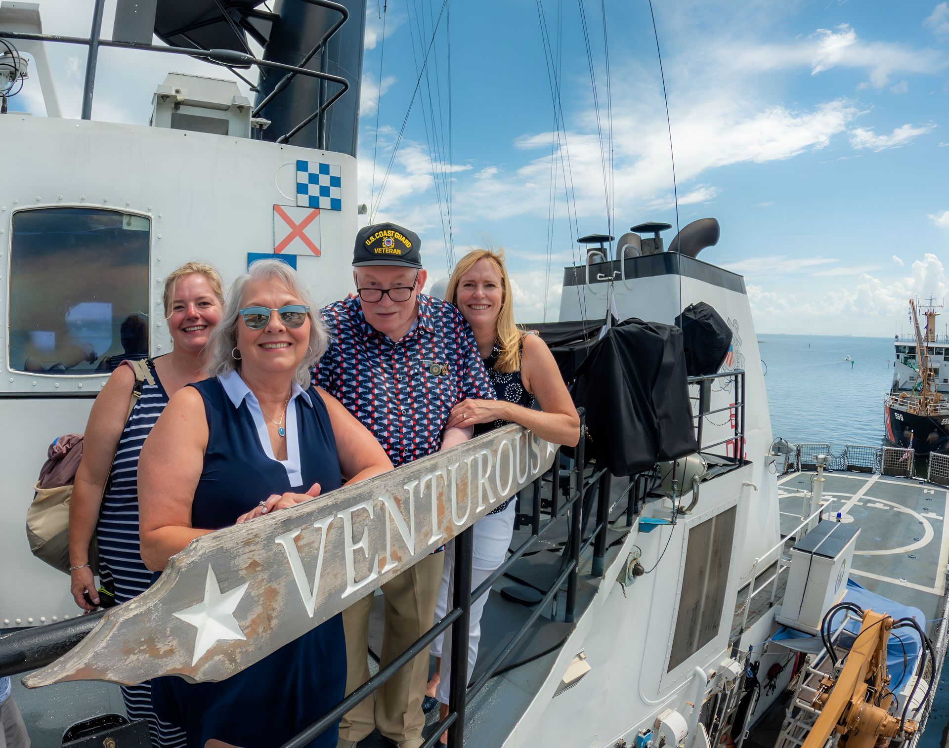 People pose on a ship deck with 