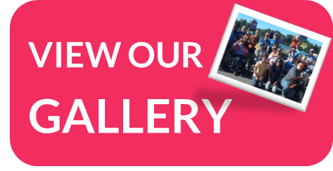Pink button with white text "VIEW OUR GALLERY" and a small photo of a group of people.