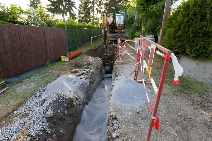 A construction vehicle is digging a hole in the ground.